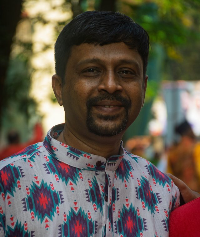 Man in a patterned shirt smiling