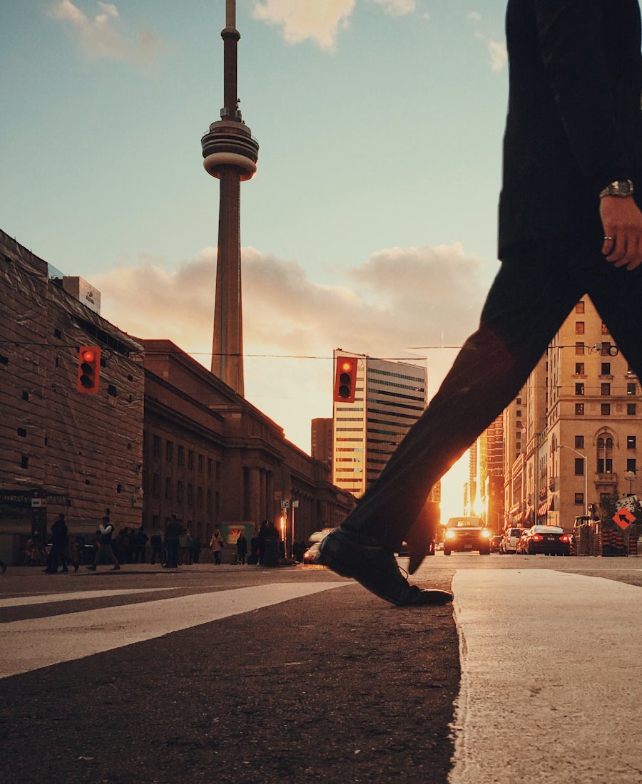 Downtown Toronto street at sunset with the CN Tower